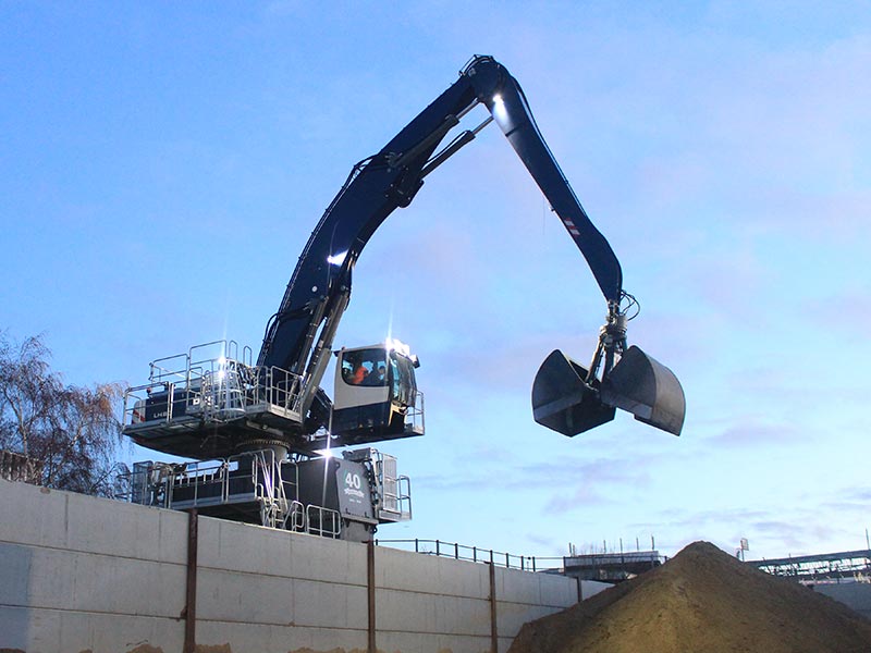 Large excavator unloading aggregates 